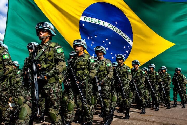 Brazilian Army soldiers in formation with the Brazilian flag in the background during a Brazilian Army Day ceremony — official anthems of Brazil